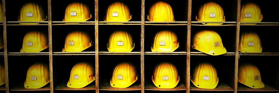Image of multiple hard hats in pigeon holes